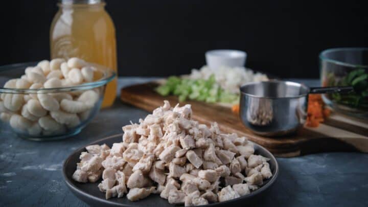 Ingredients for chicken gnocchi soup laid on a counter.