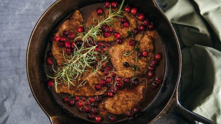 pork chops topped with cranberries and rosemary