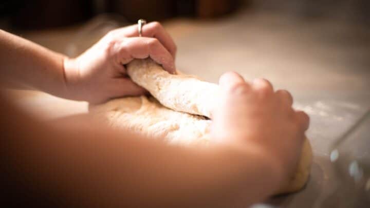 Rolling dough into loaf of bread