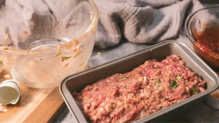Venison meatloaf pressed into a loaf pan ready to be baked.