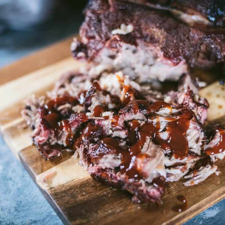 Smoked pork butt pulled apart and covered in barbecue sauce.