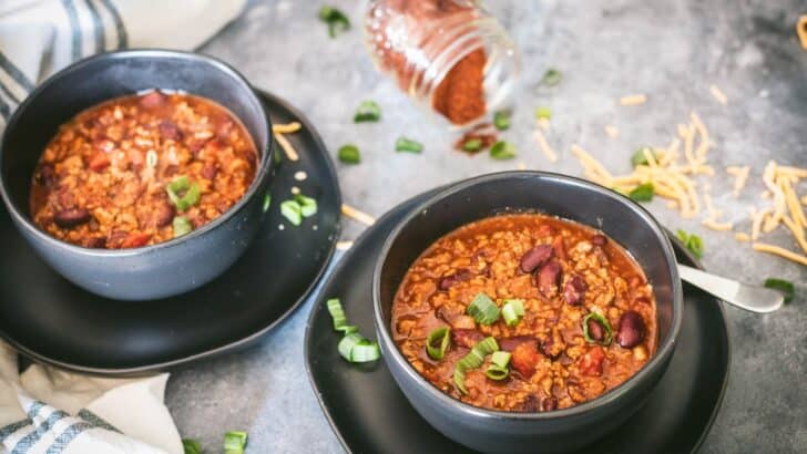 Bowls of venison chili topped with green onions.