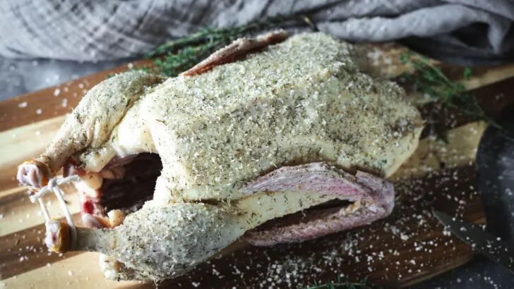 Whole duck rubbed with seasoning.