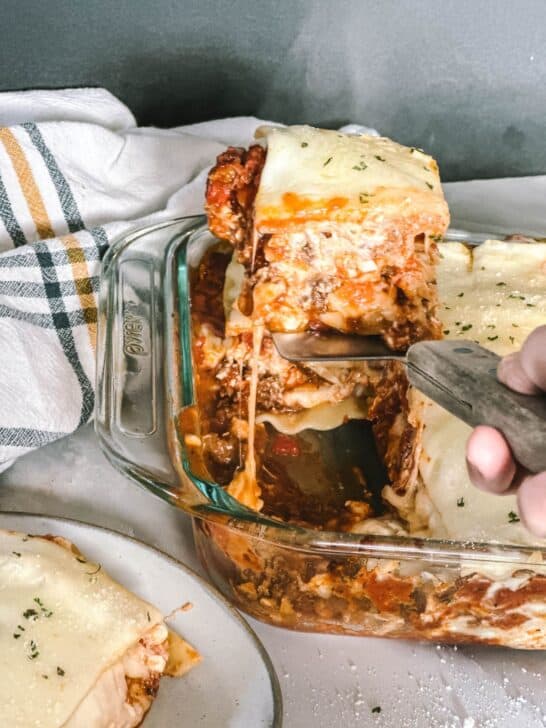 Getting a slice of homemade lasagna out of the pan.