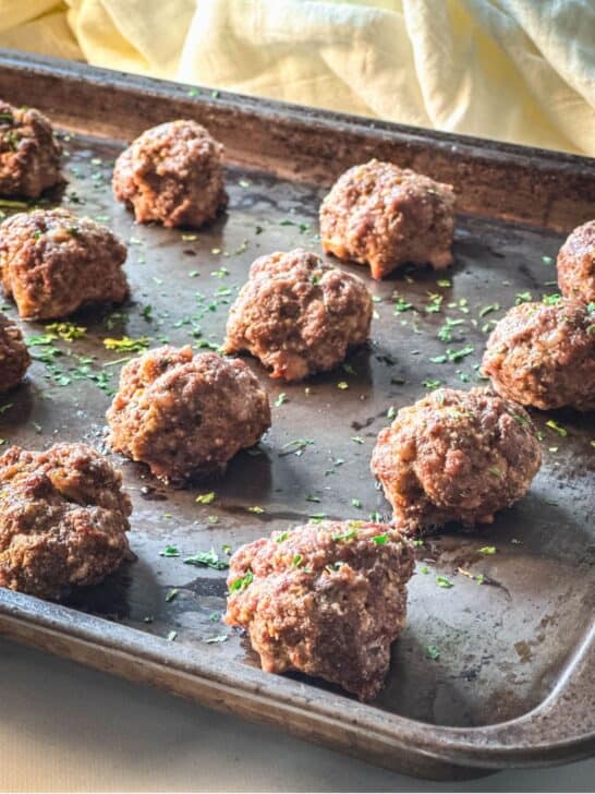 Baked venison meatballs on a baking sheet