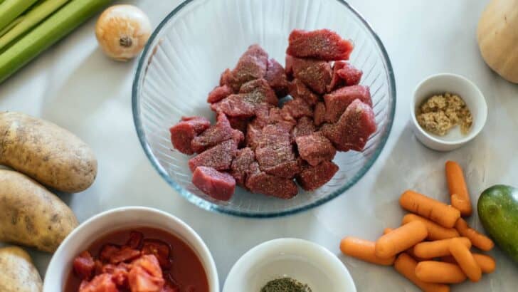 Ingredients to make vegetable beef soup laid out on a counter