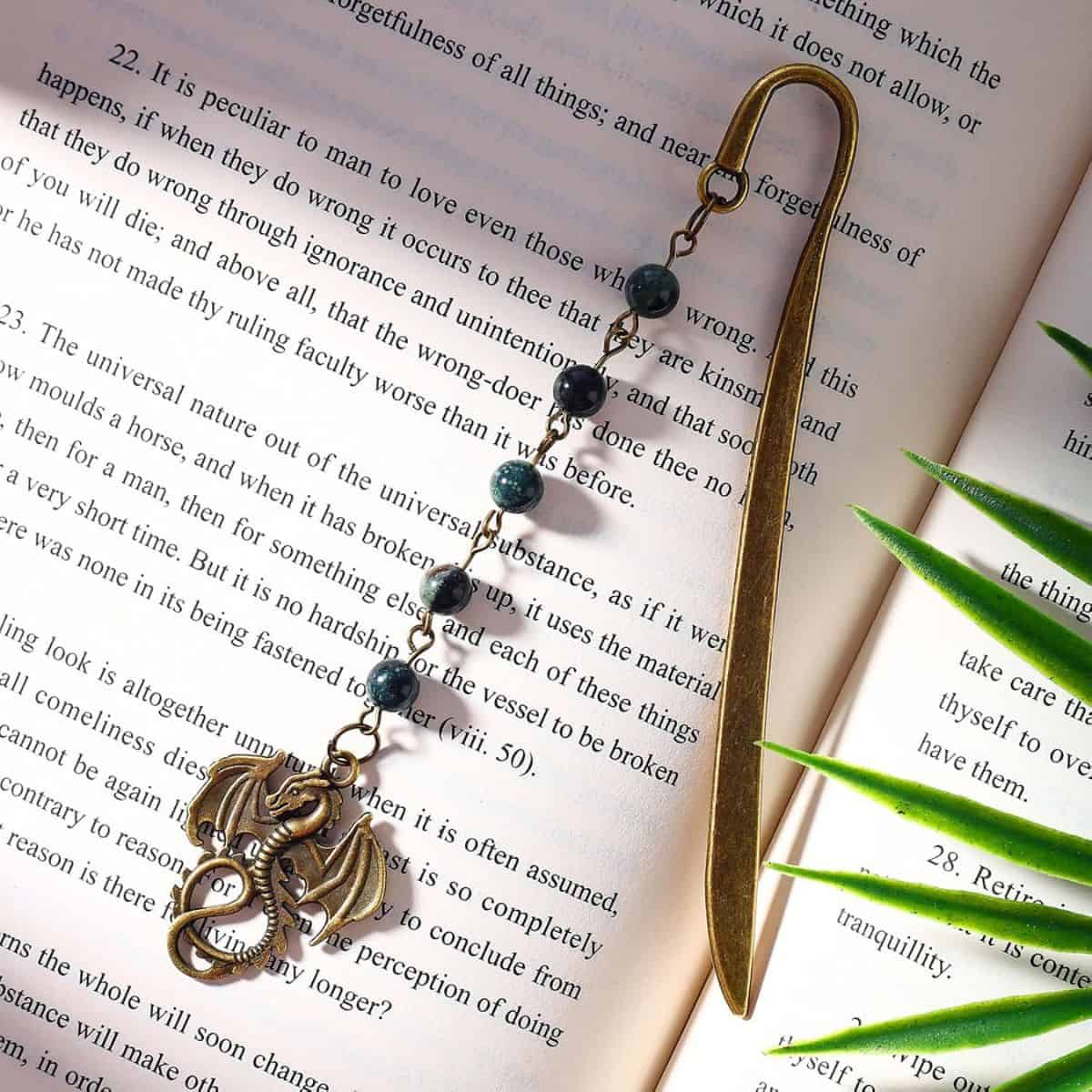 Brass dragon bookmark on a book page.