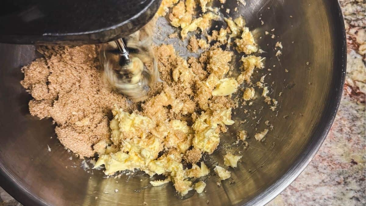 Butter and brown sugar being creamed together in a mixing bowl to start the speculaas cookie dough.