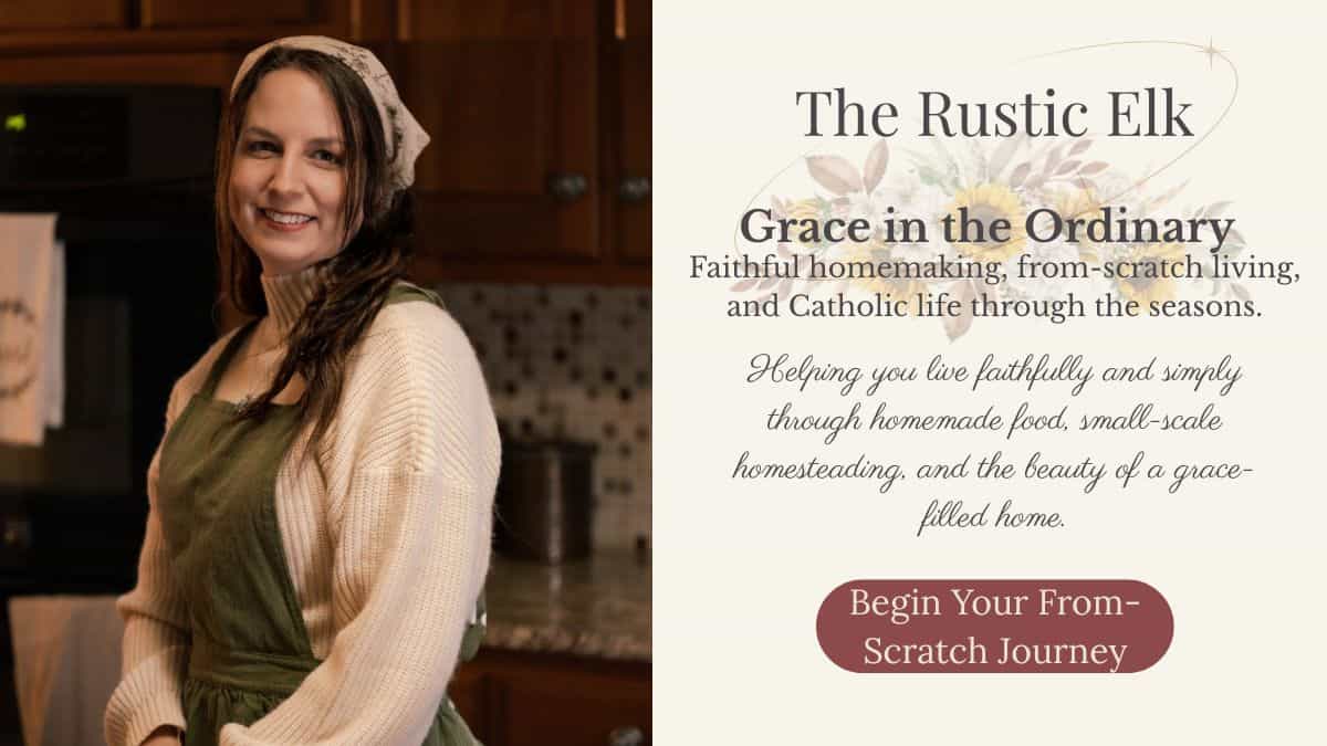 Danielle at The Rustic Elk standing in her kitchen wearing an apron and headscarf, representing faithful homemaking, from-scratch cooking, and Catholic seasonal living.