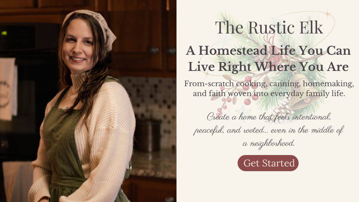Elle from The Rustic Elk standing in her kitchen wearing an apron, representing a warm, approachable homestead lifestyle focused on from-scratch cooking, canning, and faith-filled homemaking.