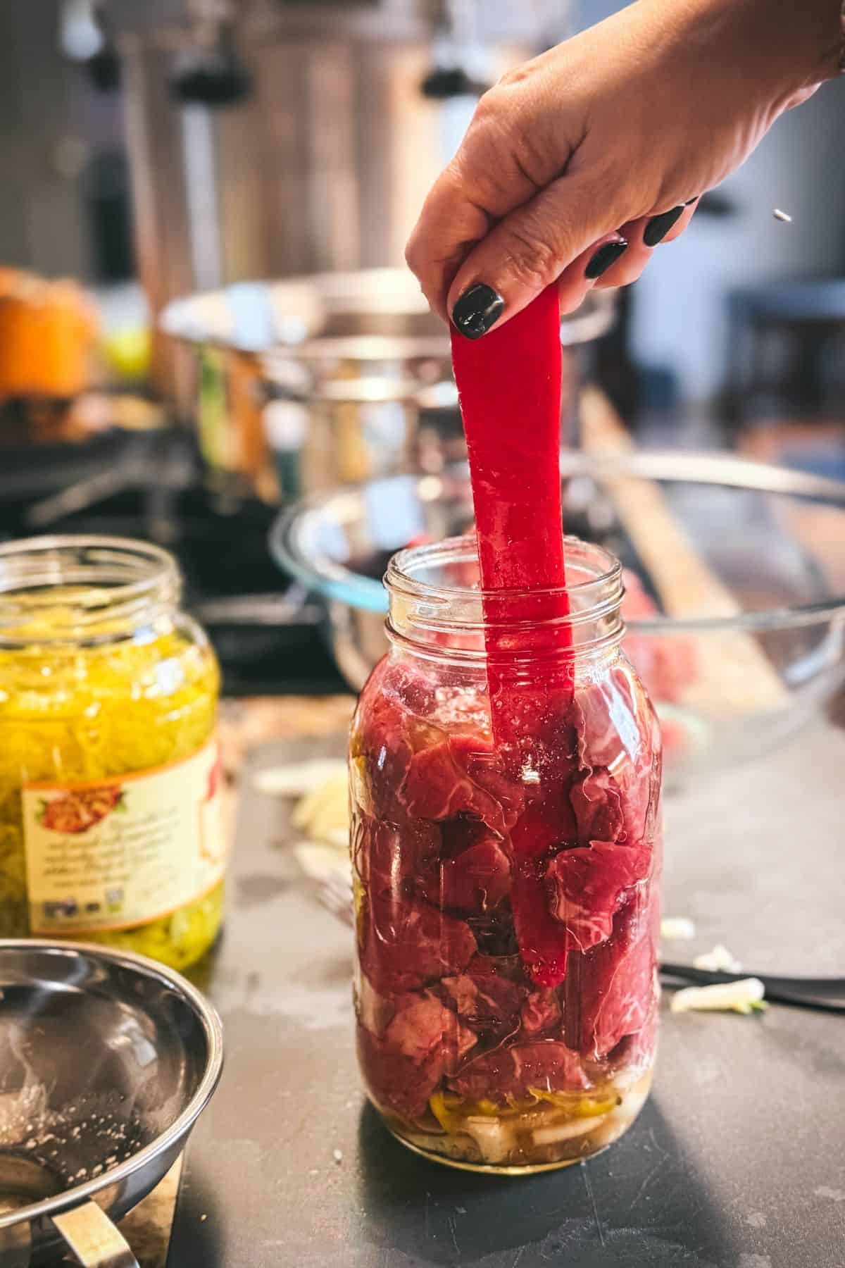 Debubbling a tightly packed raw-pack jar of Mississippi pot roast before pressure canning